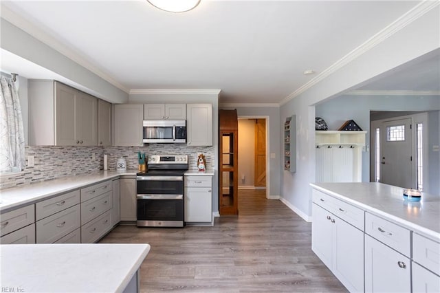 7600 Bridgette Ln, Norfolk, VA 23518 - kitchen featuring appliances with stainless steel finishes, gray cabinets, decorative backsplash, light countertops, and light wood-style floors