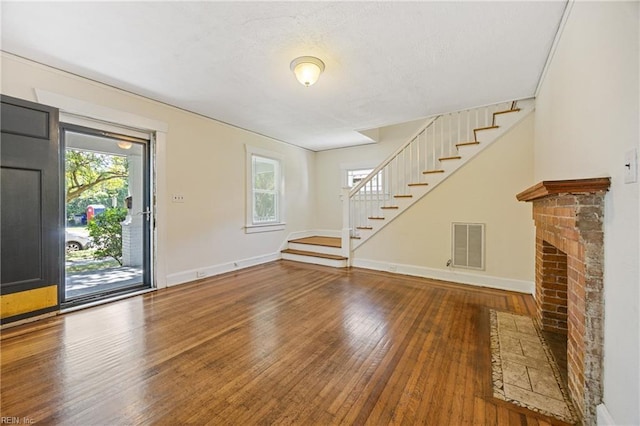5004 Powhatan Ave, Norfolk, VA 23508 - unfurnished living room featuring stairway and hardwood / wood-style flooring