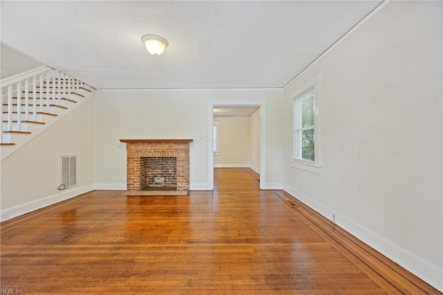 5004 Powhatan Ave, Norfolk, VA 23508 - unfurnished living room featuring stairs, wood finished floors, and a fireplace