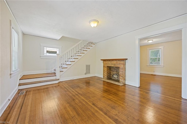 5004 Powhatan Ave, Norfolk, VA 23508 - unfurnished living room featuring stairs, wood finished floors, and a fireplace