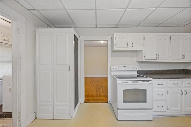 5004 Powhatan Ave, Norfolk, VA 23508 - kitchen featuring white range with electric cooktop, dark countertops, a drop ceiling, and white cabinets