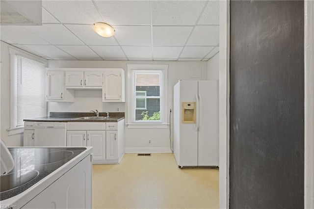 5004 Powhatan Ave, Norfolk, VA 23508 - kitchen with white appliances, dark countertops, a drop ceiling, and white cabinets