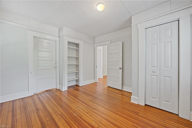 5004 Powhatan Ave, Norfolk, VA 23508 - unfurnished bedroom with light wood-style flooring and two closets