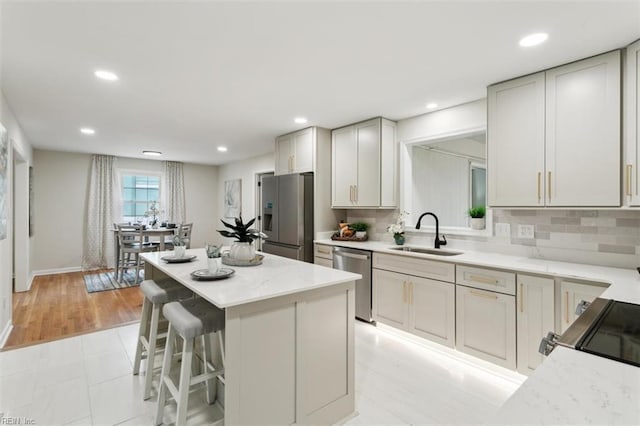 20 Westover Dr, Poquoson, VA 23662 - kitchen featuring stainless steel appliances, a center island, recessed lighting, backsplash, and a kitchen bar