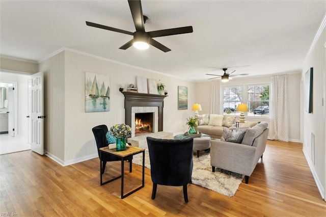 20 Westover Dr, Poquoson, VA 23662 - living room with crown molding, a ceiling fan, light wood-style flooring, and a warm lit fireplace