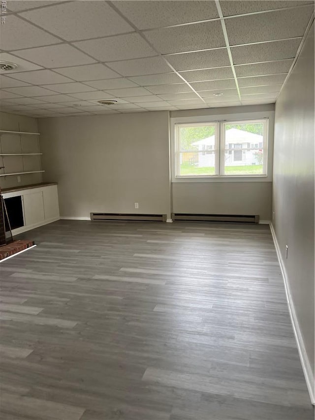2453 Malden Ave, Norfolk, VA 23518 - unfurnished living room with a baseboard heating unit, a paneled ceiling, and wood finished floors