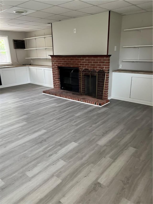 2453 Malden Ave, Norfolk, VA 23518 - unfurnished living room featuring a fireplace, wood finished floors, and a drop ceiling