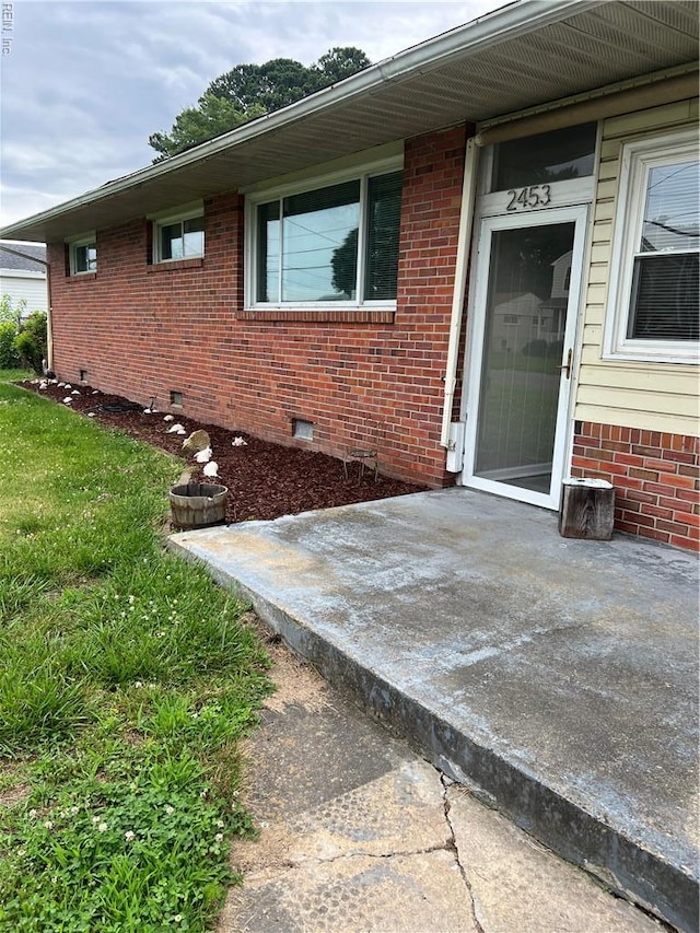 2453 Malden Ave, Norfolk, VA 23518 - view of side of home featuring crawl space, brick siding, and a patio