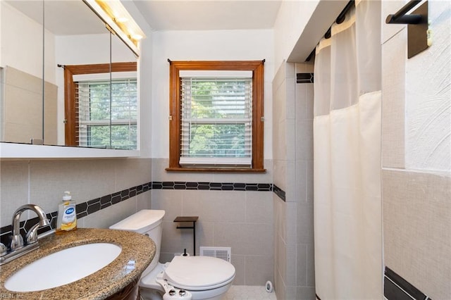 2220 Rodgers St, Chesapeake, VA 23324 - bathroom with tile walls, vanity, a shower with curtain, and wainscoting