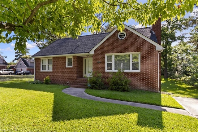 2220 Rodgers St, Chesapeake, VA 23324 - view of front of house with a chimney, a front yard, brick siding, and a shingled roof
