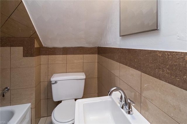 2220 Rodgers St, Chesapeake, VA 23324 - bathroom featuring tile walls and a tub to relax in
