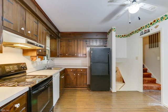 205 Haradd Ln, Williamsburg, VA 23188 - kitchen featuring black appliances, light wood-style flooring, under cabinet range hood, ceiling fan, and light countertops