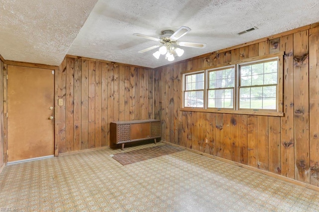 205 Haradd Ln, Williamsburg, VA 23188 - empty room with a textured ceiling, wooden walls, ceiling fan, and heating unit