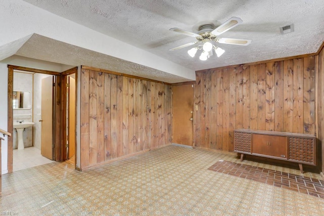 205 Haradd Ln, Williamsburg, VA 23188 - bonus room featuring a textured ceiling, wood walls, and a ceiling fan
