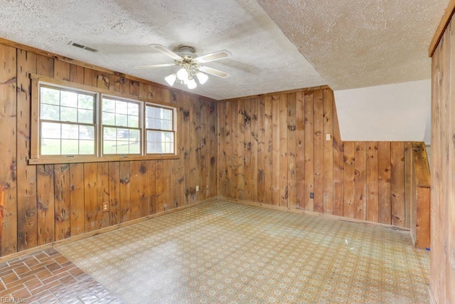 205 Haradd Ln, Williamsburg, VA 23188 - unfurnished room with wooden walls, ceiling fan, and a textured ceiling