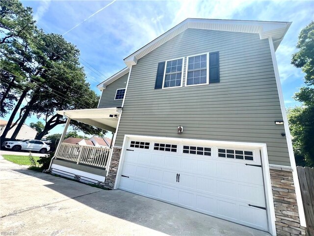 3109 Pleasant Ave, Norfolk, VA 23518 - view of home's exterior featuring a garage, stone siding, and driveway