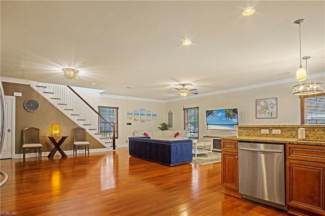 3109 Pleasant Ave, Norfolk, VA 23518 - kitchen with stainless steel dishwasher, brown cabinetry, wood finished floors, ornamental molding, and pendant lighting