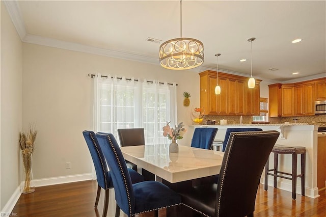 3109 Pleasant Ave, Norfolk, VA 23518 - dining room with dark wood finished floors, a chandelier, ornamental molding, and recessed lighting