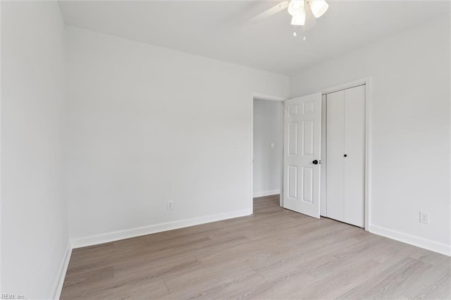 13067 Poor House Rd, Windsor, VA 23487 - unfurnished bedroom featuring light wood finished floors, a closet, and ceiling fan