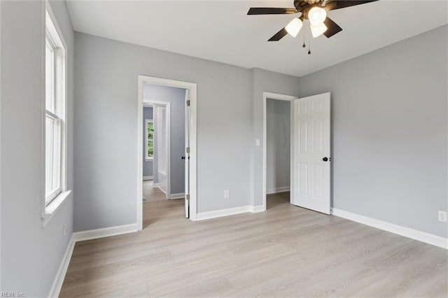 13067 Poor House Rd, Windsor, VA 23487 - unfurnished bedroom featuring light wood finished floors and ceiling fan