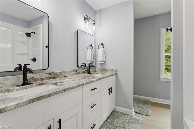 13067 Poor House Rd, Windsor, VA 23487 - bathroom featuring wood finished floors, double vanity, and a shower