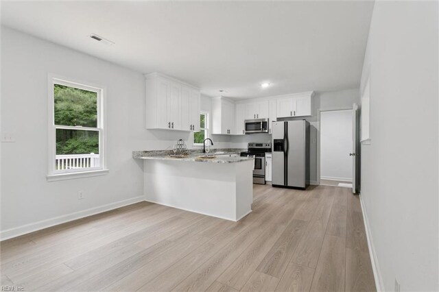 13067 Poor House Rd, Windsor, VA 23487 - kitchen with stainless steel appliances, light wood-style flooring, light countertops, white cabinetry, and recessed lighting