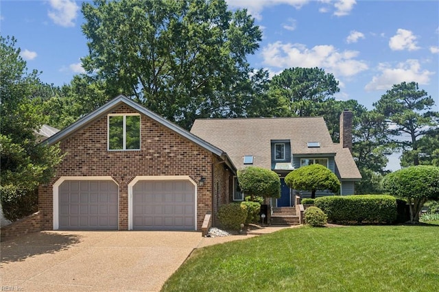 133 Randolphs Grn, Williamsburg, VA 23185 - view of front facade with concrete driveway, a front lawn, brick siding, a chimney, and an attached garage
