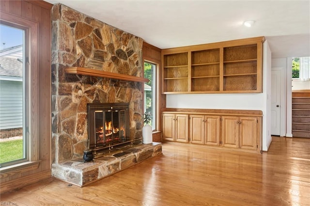133 Randolphs Grn, Williamsburg, VA 23185 - unfurnished living room with light wood finished floors and a stone fireplace