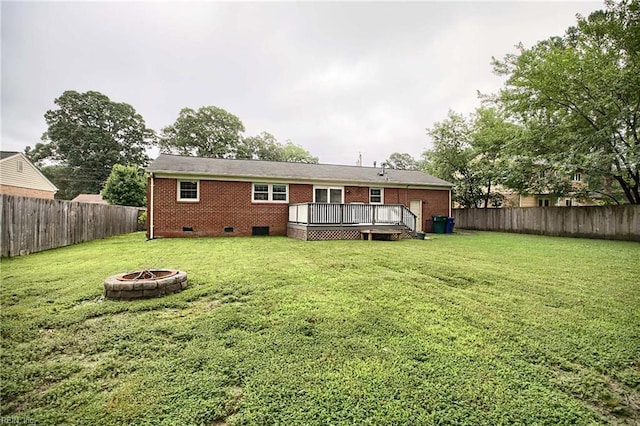 845 Cascade Dr, Newport News, VA 23608 - rear view of house with crawl space, an outdoor fire pit, a fenced backyard, a wooden deck, and brick siding