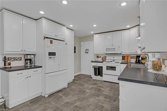 845 Cascade Dr, Newport News, VA 23608 - kitchen featuring white appliances, dark countertops, backsplash, white cabinetry, and recessed lighting