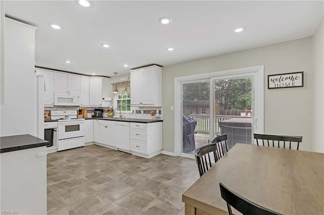 845 Cascade Dr, Newport News, VA 23608 - kitchen featuring white appliances, dark countertops, white cabinetry, recessed lighting, and decorative light fixtures