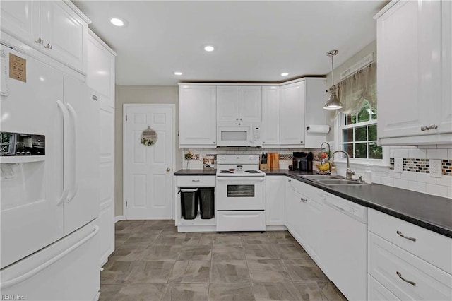 845 Cascade Dr, Newport News, VA 23608 - kitchen with white appliances, dark countertops, white cabinets, tasteful backsplash, and recessed lighting