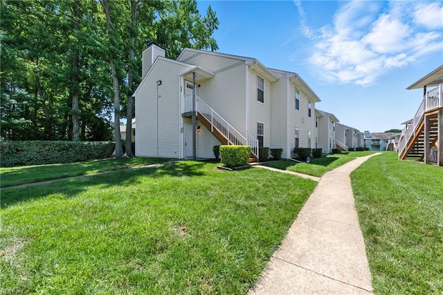 628 Crows Nest Ct Unit 101, Virginia Beach, VA 23462 - view of property exterior featuring stairway, a chimney, and a lawn