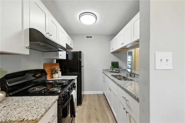 628 Crows Nest Ct Unit 101, Virginia Beach, VA 23462 - kitchen with black electric range, under cabinet range hood, light wood-style floors, white cabinetry, and a textured ceiling