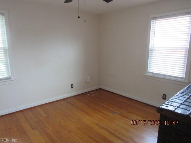 504 W Little Creek Rd, Norfolk, VA 23505 - empty room featuring a ceiling fan, wood finished floors, and plenty of natural light