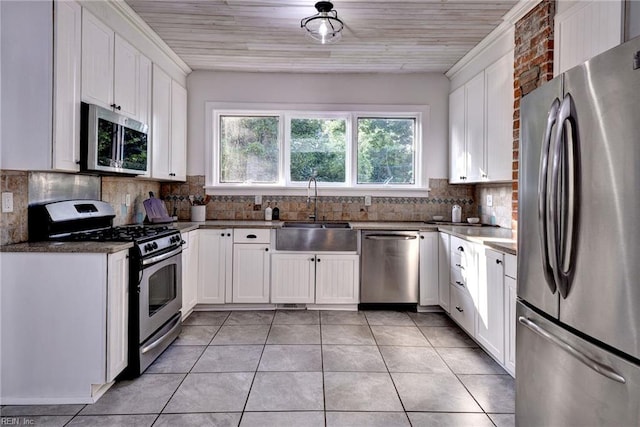 826 Lee St, West Point, VA 23181 - kitchen featuring appliances with stainless steel finishes, white cabinetry, light tile patterned flooring, and tasteful backsplash