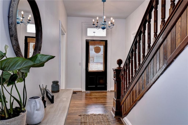 826 Lee St, West Point, VA 23181 - entryway with a chandelier, dark wood finished floors, stairs, arched walkways, and healthy amount of natural light