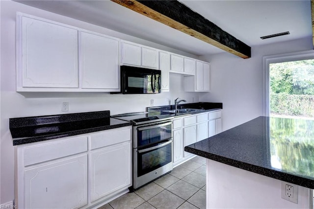 826 Lee St, West Point, VA 23181 - kitchen with black microwave, double oven range, beam ceiling, white cabinetry, and dark countertops