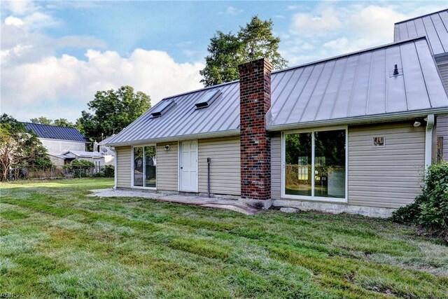826 Lee St, West Point, VA 23181 - rear view of property featuring a standing seam roof, a metal roof, and a chimney