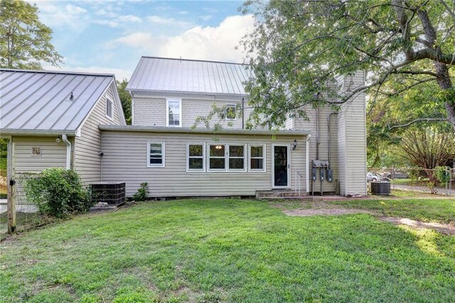 826 Lee St, West Point, VA 23181 - rear view of property with a standing seam roof, a lawn, and a metal roof