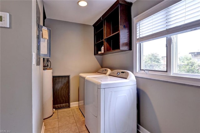 826 Lee St, West Point, VA 23181 - laundry area featuring washer and dryer, cabinet space, light tile patterned floors, and gas water heater