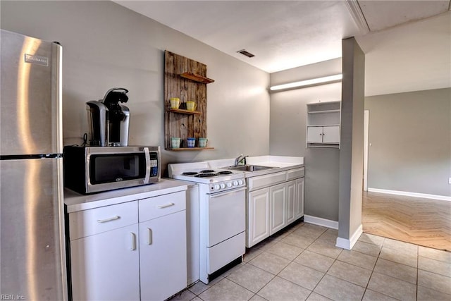 826 Lee St, West Point, VA 23181 - kitchen featuring appliances with stainless steel finishes, open shelves, light countertops, and white cabinetry