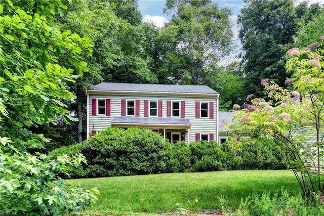 308 Royal Grant Dr, Williamsburg, VA 23185 - colonial house featuring a front yard and view of wooded area