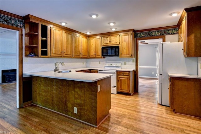 308 Royal Grant Dr, Williamsburg, VA 23185 - kitchen featuring white appliances, light wood-style floors, a peninsula, and light countertops