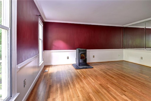 308 Royal Grant Dr, Williamsburg, VA 23185 - unfurnished room featuring wood finished floors, a wood stove, and crown molding