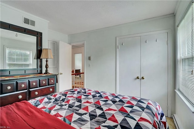 713 Bishop Dr, Virginia Beach, VA 23455 - bedroom featuring a baseboard heating unit, a closet, and crown molding