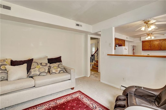 713 Bishop Dr, Virginia Beach, VA 23455 - living area featuring light carpet, ceiling fan, a baseboard radiator, and stairway