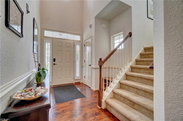 5560 Botanical Dr, Virginia Beach, VA 23455 - foyer entrance featuring a textured wall, wood-type flooring, stairs, and a towering ceiling