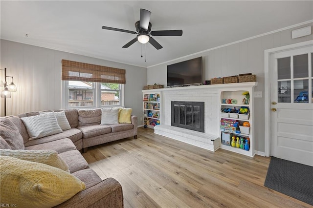 2440 Sir Lance Dr, Chesapeake, VA 23325 - living area featuring a ceiling fan, wood finished floors, ornamental molding, and a brick fireplace