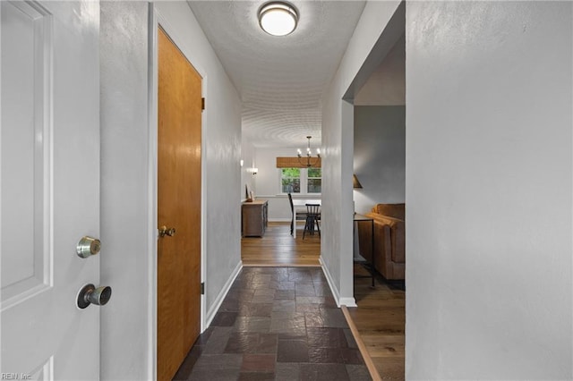 2440 Sir Lance Dr, Chesapeake, VA 23325 - hall featuring dark stone finish floors and a chandelier